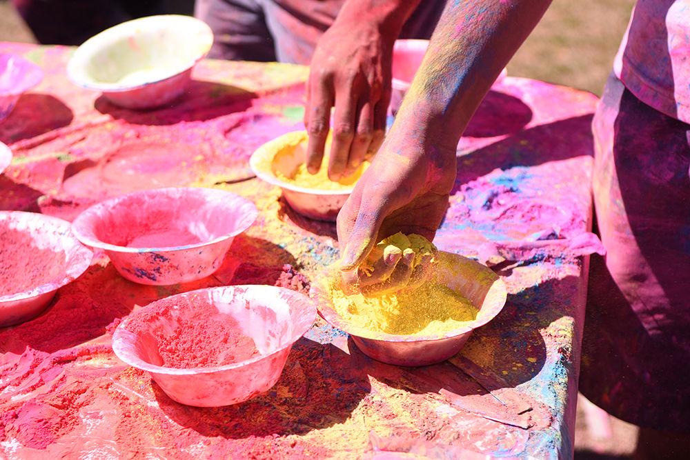 Hands grab at bowls of powder at Holi on Sunday, March 24, at Lee Field. In addition to Holi, the powders are also used in other Hindu rituals, and have been incorporated into some Western celebrations.