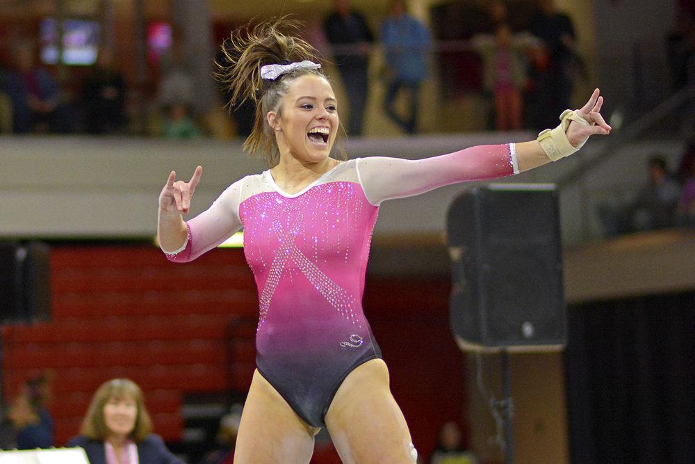*Editor's note: the original photo has been replaced.Senior Paris Phillips shoots wolfies during her floor routine at the meet against Pitt on Saturday, Feb. 9 at Reynolds Coliseum. Phillips tied for second in the floor exercise. The Wolfpack defeated the Panthers 196.400 to 194.825.