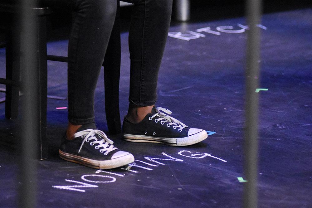 Words written on the floor reflect the words that Michelle, played by Dani Coan, an engineering first year student, thinks of herself during a dress reversal for A Good Little Rain on Monday, March 18, in Thompson Hall. The show will run March 20-24 in Kennedy-McIlwee Studio Theatre in Thompson Hall.