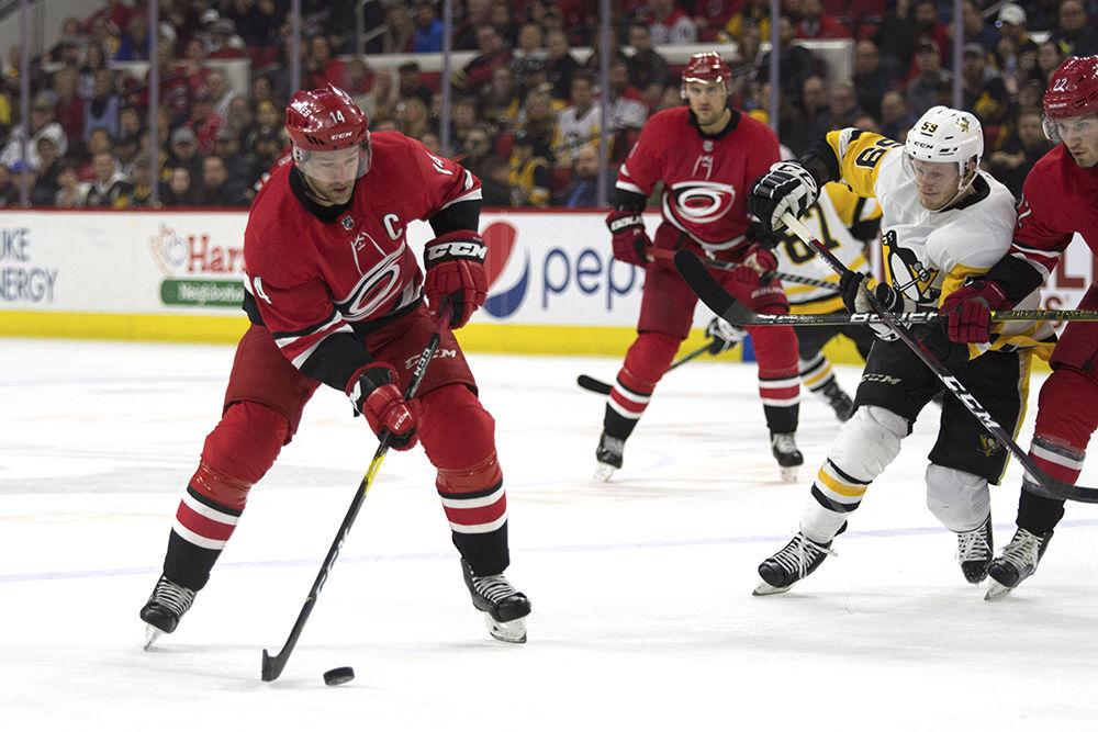 Right winger Justin Williams dribbles the puck into Pittsburgh Penguins territory in PNC Arena, Tuesday, March 19. Williams went on to score during the third period, tying the game 2-2, leading to an overtime victory by Dougie Hamilton. The Canes won at home, 3-2.&#160;