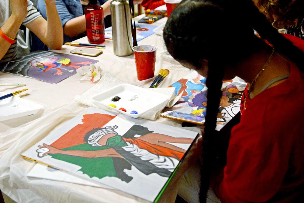 Canvas Club member Leana Ibrahim, a first-year in human biology, paints with other Canvas Club members on Monday, March 25, 2019 in Mann 404. Canvas Club members pay a $10 fee for the materials they will use the rest of the semester. The club meets once a week to paint together as a community.