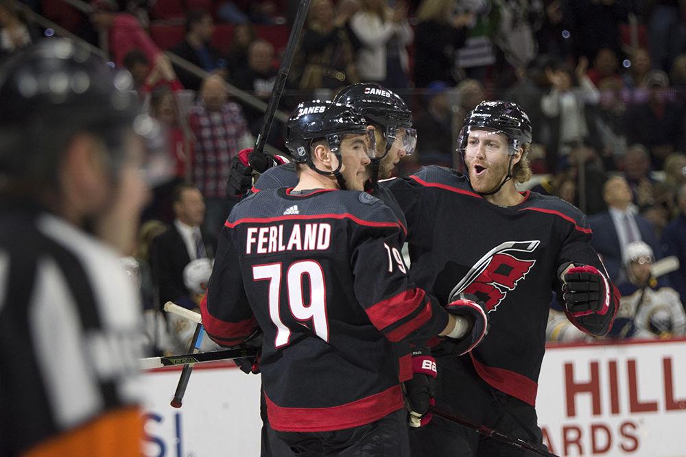 Left winger Michael Ferland, center Jordan Staal, and defenseman Dougie Hamilton celebrate the game winning goal late in the third period against the Buffalo Sabres, Saturday, March 16 in PNC Arena. The Canes won 4-2.