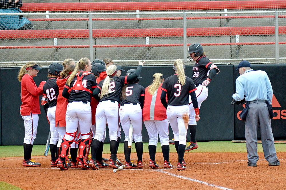 Junior utility player Brigette Nordberg is greeted by her teammates after hitting a homerun. Sunday, Feb. 17 at Dail Softball Stadium. Nordberg had two runs batted in and one runs scored. The Wolfpack lost against Wisconsin 6-3.