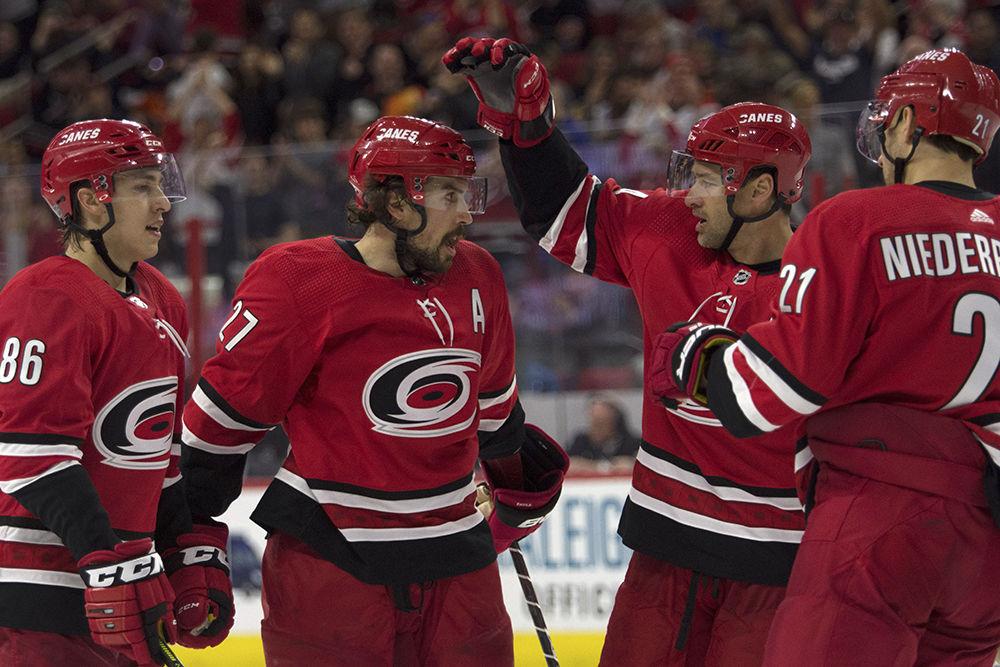 Defenseman Justin Faulk celebrates with teammates after scoring on a power play early in the third period in PNC Arena, Saturday, March 30. The Canes won against the Flyers, 5-2 in regulation time.&#160;