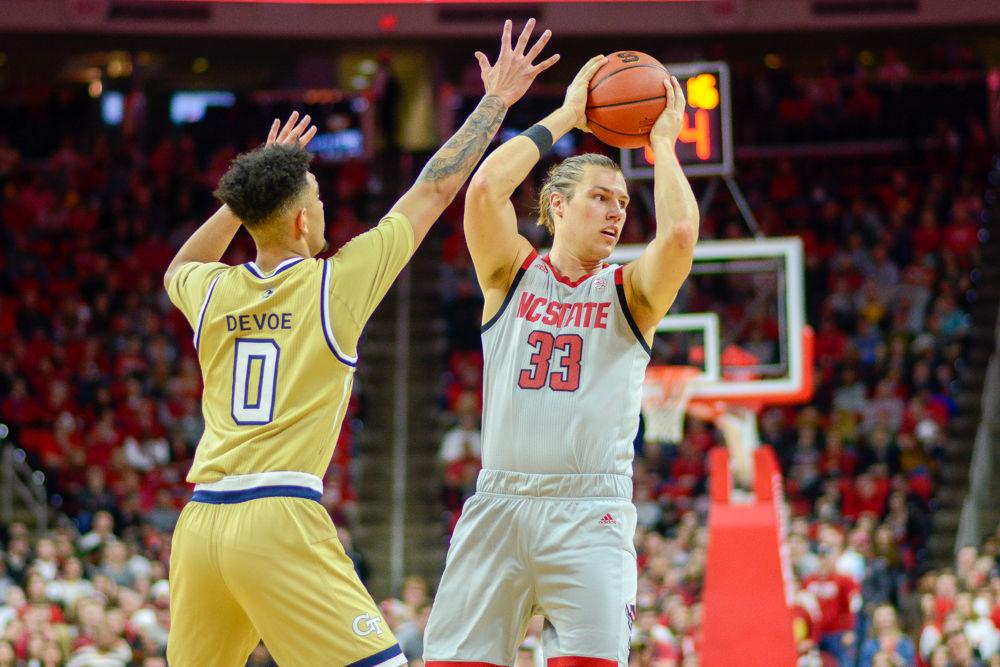 Graduate forward Wyatt Walker looks for a teammate to pass to during the game against Georgia Tech on Wednesday, March 6 in PNC Arena. The Wolfpack lost to the Yellow Jackets 63-61.