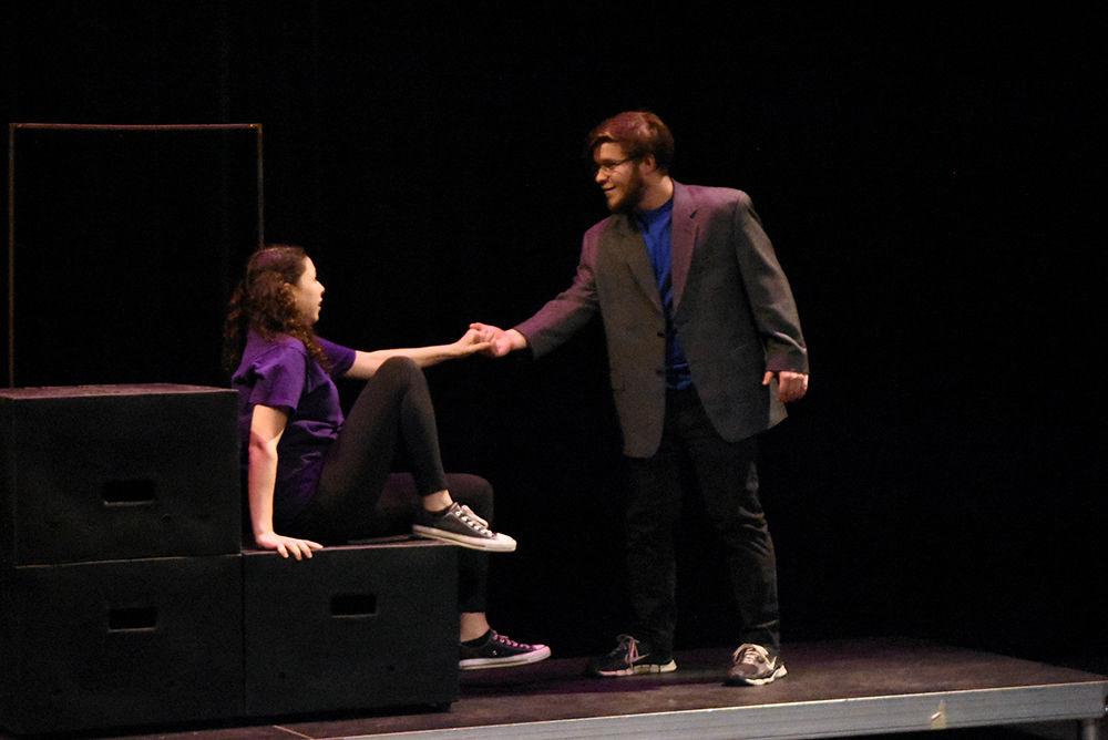 Young Michelle, played by Gracelyn Kitchings, a first-year studying communication, holds the hand of her grandfather, played by Carl Staub, a fourth-year studying communication, during a dress rehersal for A Good Little Rain on Monday, March 18, in Thompson Hall. The show will run March 20-24 in Kennedy-McIlwee Studio Theatre in Thompson Hall.