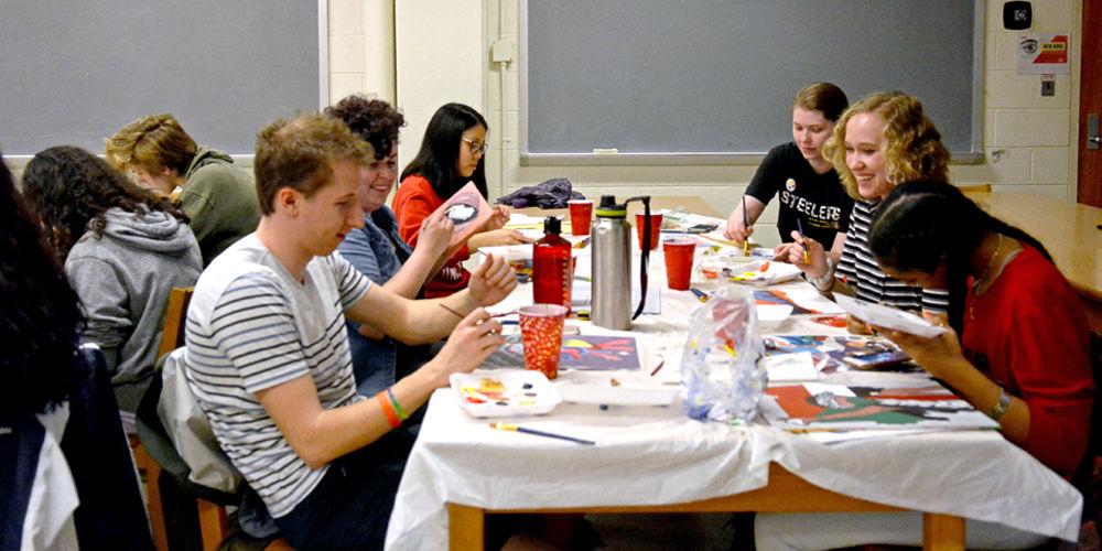Canvas Club members paint Monday nights this semester in Mann 404 on March 25. Canvas Club members pay a $10 fee for the materials they will use the rest of the semester. They meet once a week to paint together as a community.