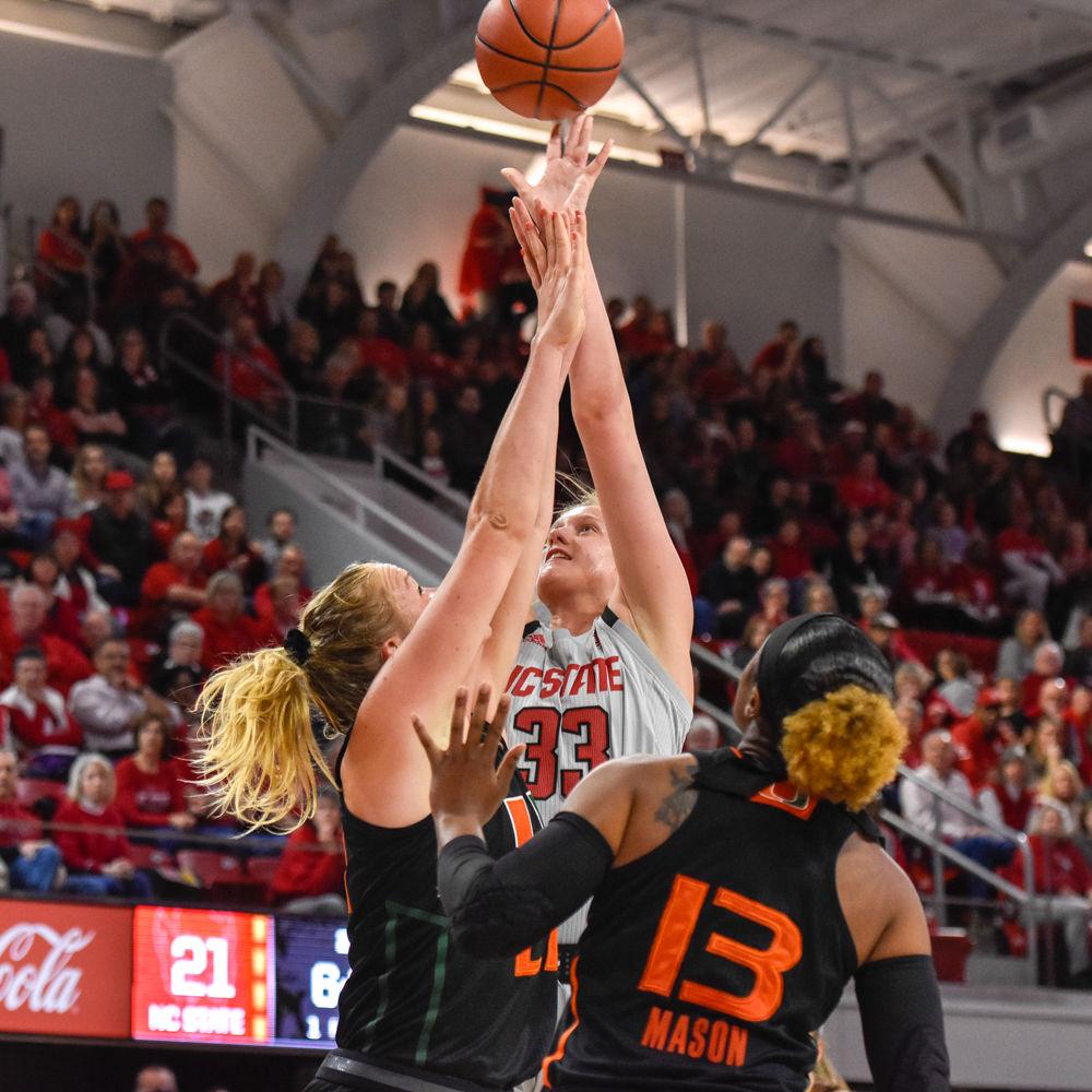 Freshman center Elissa Cunane shoots the ball in Reynolds Coliseum on Sunday, March 3. She scored a total of 11 points and the Wolfpack won 70-68 against the Miami Hurricanes.