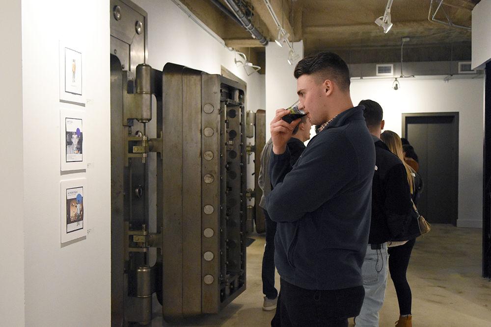 Max Crownover, a third-year studying political science and history,&#160;looks at art pieces on the wall at the Fish Market Student Gallery on Feb. 1 in downtown Raleigh. This event was part of Raleigh&#8217;s First Friday program, an initiative by the Downtown Raleigh alliance to promote awareness of Raleigh&#8217;s creative community.
&#160;