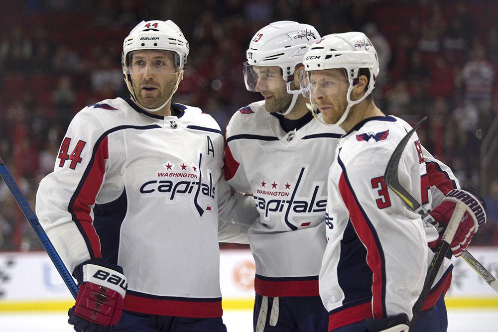 Washington Capitals right winger Brett Connolly celebrates his goal with teammates Brooks Orpik and Nick Jensen in PNC Arena, Thursday, March 28. The Canes lost to the Caps in regulation, 2-3.&#160;
