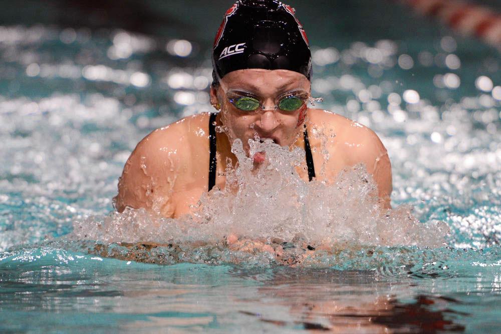 Current-senior Emmie Barnhill swims the 100 yard breastroke during the meet against UNC-Chapel Hill at Willis R. Casey Aquatic Center on Jan. 26, 2017. Emmie Barnhill&#8217;s parents, JoAnn and Kelly Barnhill, both NC State alums, founded the&#160;Barnhill Family Student Success Endowment.