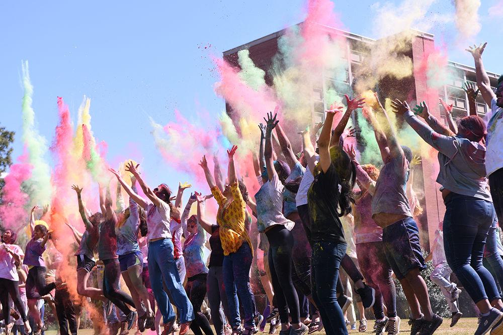Participants of Holi throw colored power in the air on Sunday, March 24 at Lee Field. Holi, also known as the Festival of Colors, is an Indian holiday that celebrates the arrival of spring.