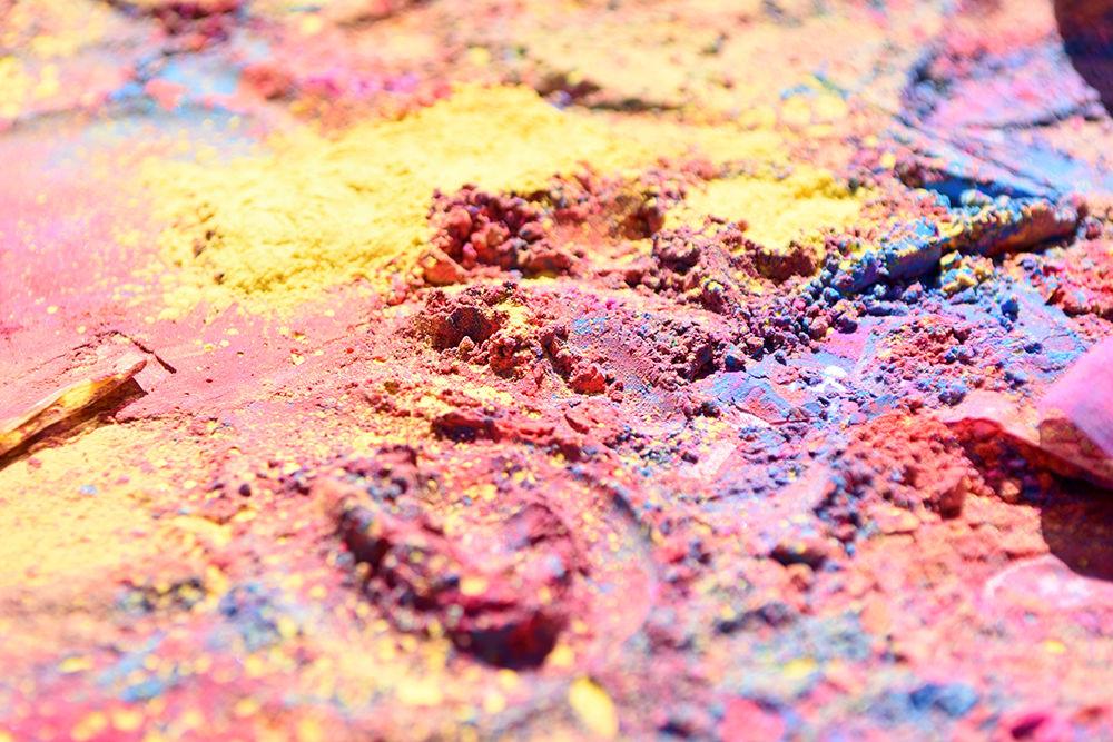 Colored powders, known as gulal, sit spilled on a table at the Holi event at Lee field on Sunday, March 24. The event was organized by MAITRI together with Ektaa and DSI.
