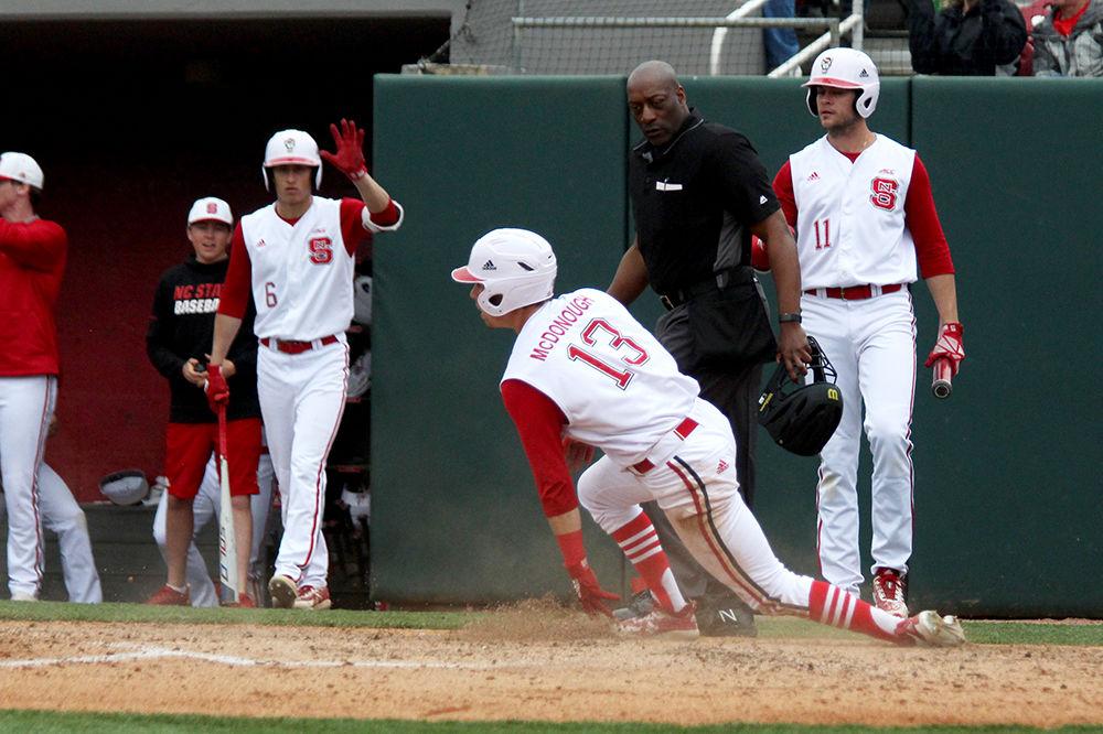Freshman center field, Tyler McDonough slides to home plate during the game against the Virginia Cavaliers on Sunday, March 31, at Doak Field. McDonough had a total of two hits with one double and one home run, two runs, two RBI&#8217;s and two put outs in the Wolfpack's 8-7 win.