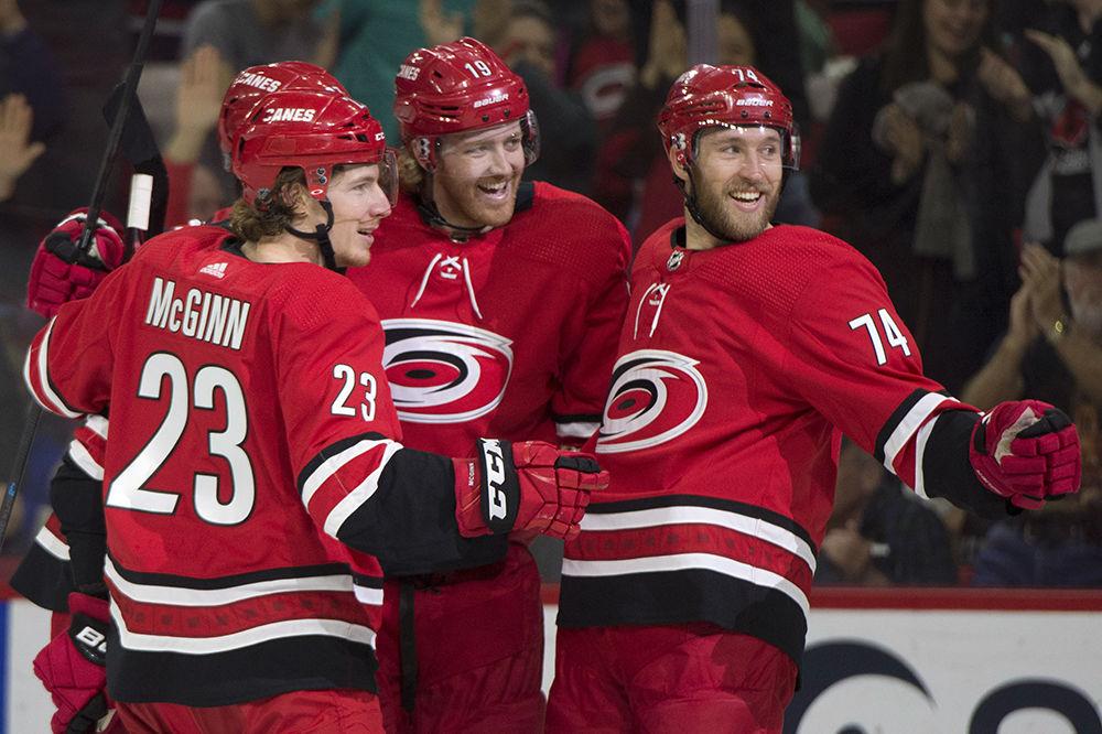 Defenseman Dougie Hamilton celebrates his goal with teammates Brock McGinn and Jaccob Slavin, establishing an early lead in the first period against the Philadelphia Flyers in PNC Arena, Saturday, March 30. The Canes won 5-2 in regulation.&#160;