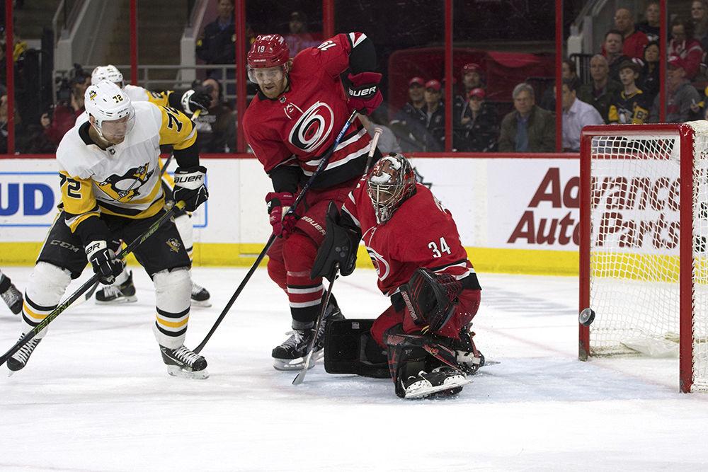 Goaltender Petr Mrazek watches the puck rebound from his pads as the Pittsburgh Penguins fight for control of the puck, Tuesday, March 19 in PNC Arena. Mrazek defended against 36 shots on goal, only letting two slip through during regulation. The Canes won in a shootout, 3-2.&#160;