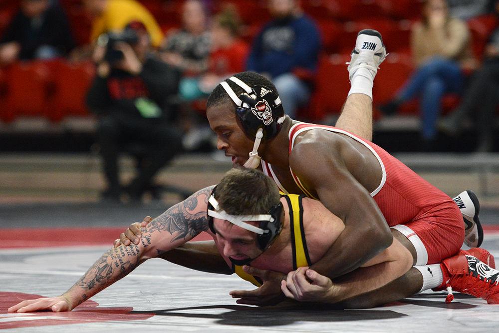 Tariq Wilson, in the 133-pound weight class, wins 5-2 over Appalachian State&#8217;s Codi Russell in Reynolds Coliseum on Dec. 4. The Wolfpack won the dual 29-9.