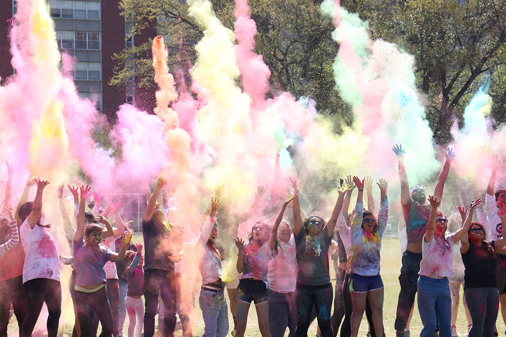 Participants of the Holi Festival throw paint up in the air simultaneously on March 24, at Lee Field. Holi is a Hindu festival of colors that celebrates the victory of good over evil.