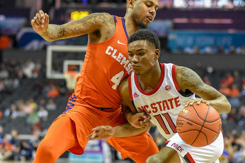 Junior guard Markell Johnson drives to the basket during ACC Tournament game versus the Clemson Tigers on Wednesday, March 13, 2019 in the Spectrum Center. Johnson scored 23 points and led the Wolfpack team in points. Johnson's performance against the Tigers helped the team overcome a 16 point deficit at the end of the first half. The Wolfpack beat Clemson 59-58.