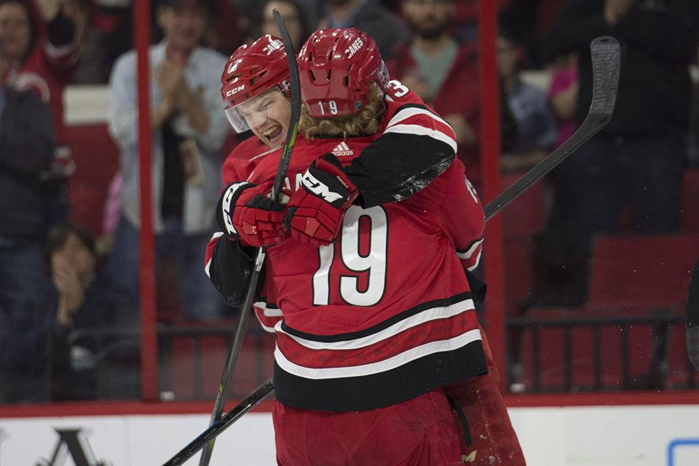Left wing Warren Foegele tackles defenseman Dougie Hamilton after scoring in the last home game of the regular season, Thursday, April 4. Foegele tied up the game, aiding in a playoff-clinching 3-1 victory over the New Jersey Devils.