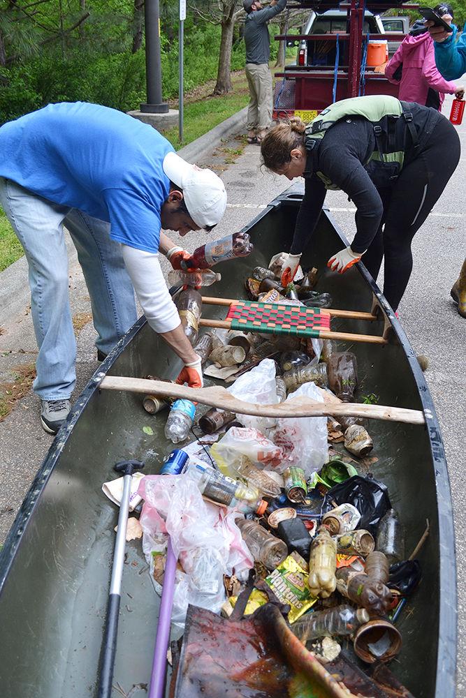 Dewang Bhavsar, a resident of Fuquay-Varina, and Elisa Crisci, a professor in the College of Vetinary Medicine, sort trash collected from the bank of Lake Raleigh during the Earth Day Cleaup and Service Day sponsored by NC State Wellness and Recreation on Sunday, April 21. Over a dozen volunteers collected over a hundred pounds of trash from the Lake.