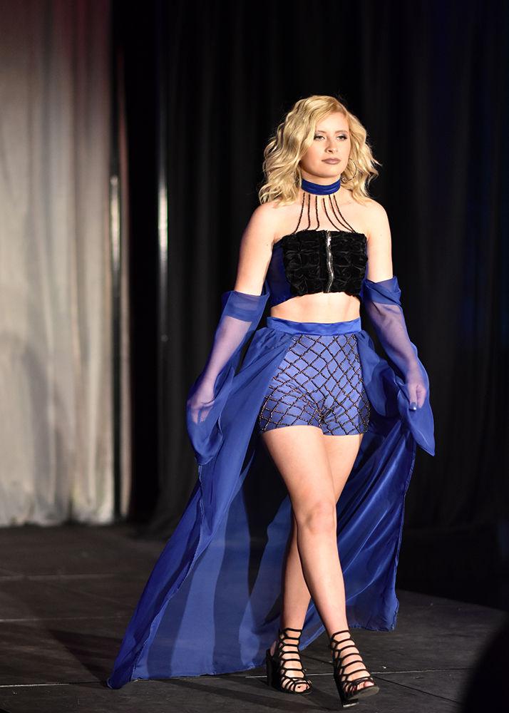 Leading her flowing train, a model from Ariel Roman's She's No Angel collection struts down the runway at the PANAF 22nd Annual Fashion Expose in Tally on Thursday, April 11.