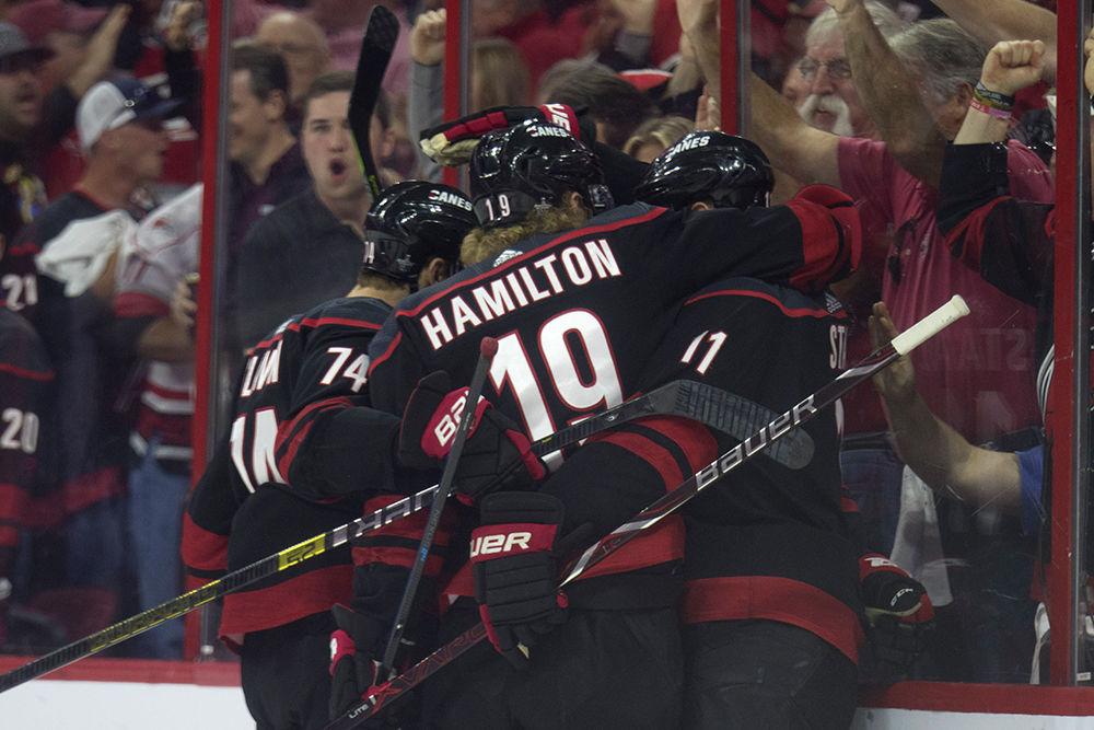 Teammates swarm around Warren Foegele after scoring a goal only 0:17 seconds into the first period of the game, Thursday, April 18 in PNC Arena. The Canes defeated the defending Stanley Cup champions again to tie the series 2-2. The Canes return to PNC Arena Monday, April 22 after a brief detour in Washington D.C. for game five.