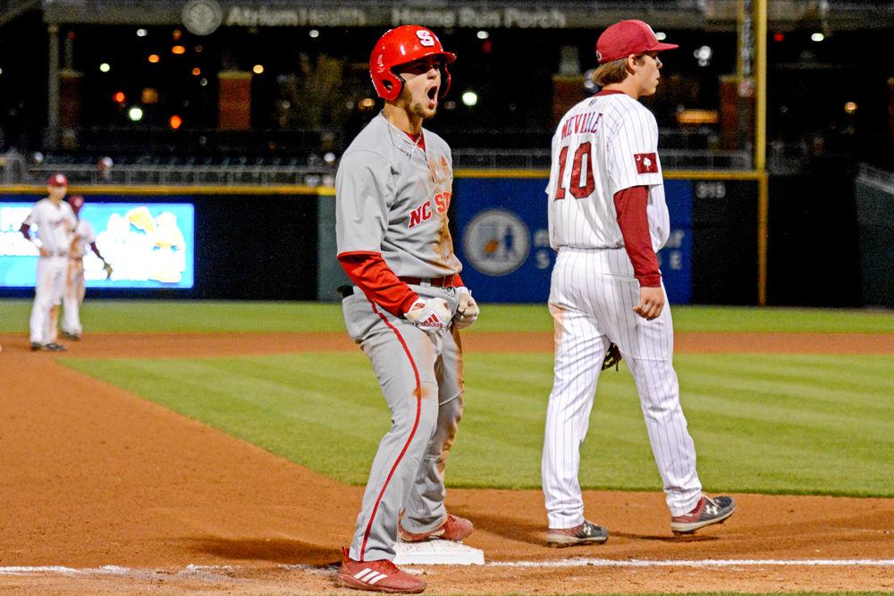 Junior infielder Will Wilson celebrates after hitting a triple and allowing the Pack to score two runs to tie the game against South Carolina on Tuesday, April 2, 2019 at BB&amp;T Ballpark in Charlotte. Wilson had four hits, one of which was a home run. The Wolfpack lost to the Gamecocks 10-8 on a walk-off home run.