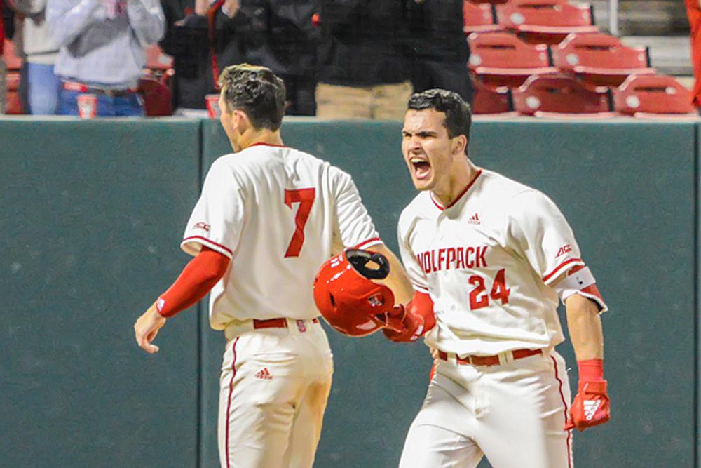 Freshman catcher and outfielder Luca Tresh celebrates with sophomore infielder David Vazquez after hitting a home run against Virginia on Friday, March 29, 2019 at Doak Field. The Wolfpack lost 4-3.