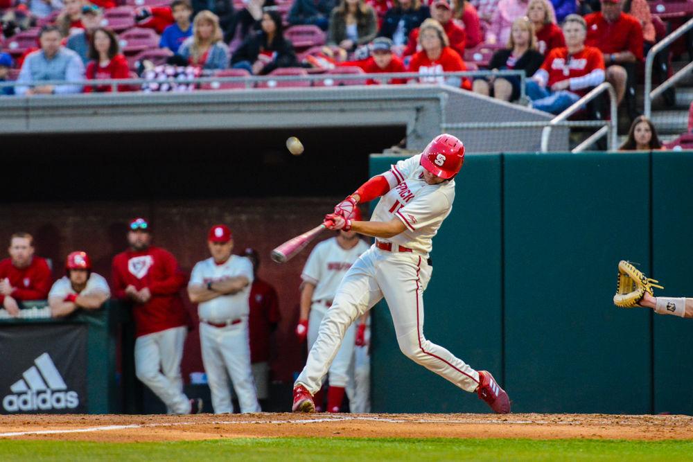Junior outfield Lawson McArthur hits a pitch against Virginia on Friday, March 29, 2019 at Doak Field. The Wolfpack lost 4-3.