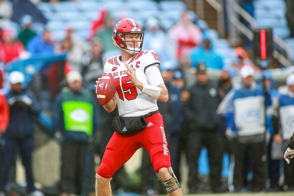 Graduate quarterback Ryan Finley goes through his progression. Finley had 200 yards and one interception. The Wolfpack struggled but was able to put away UNC in overtime for a 34-28 win on Saturday, Nov. 24 in Kenan Memorial Stadium.