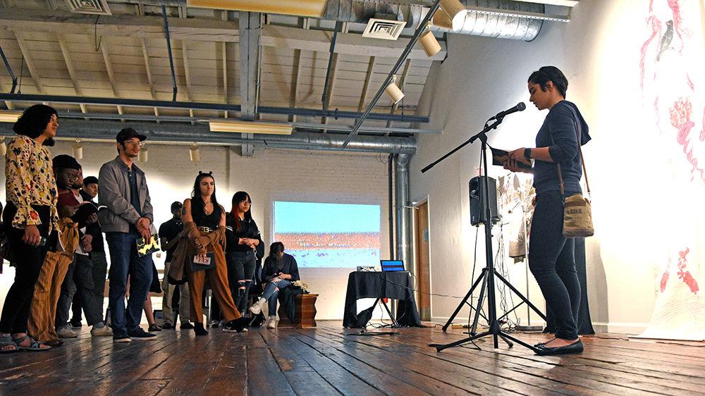 Claire Spina, a fourth-year studying science, technology, and society, reads her piece, &#8216;Zugunruhe,&#8217; at the Windhover release party at Artspace on Friday, April 12. Windhover is NC State&#8217;s literary and arts magazine and collects writing, photography, art, music and film for their yearly publication.
