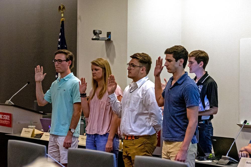 Student Senate President Mitchell Moravec, a graduate student studying public administration, walks newly appointed senators through the oath of office during the student senate meeting in Talley on Wednesday, April 24. Student senate meetings happen in room 4140 bi-weekly on Wednesdays.