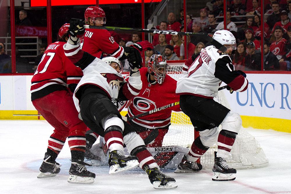 Admist a slew of players, goalie Petr Mrazek stops the Arizona Coyotes from scoring, Sunday, Dec. 16 in PNC Arena. Mrazek stopped 23 shots on goal from becoming points, helping the Hurricanes take a 3-0 victory over the Coyotes.&#160;