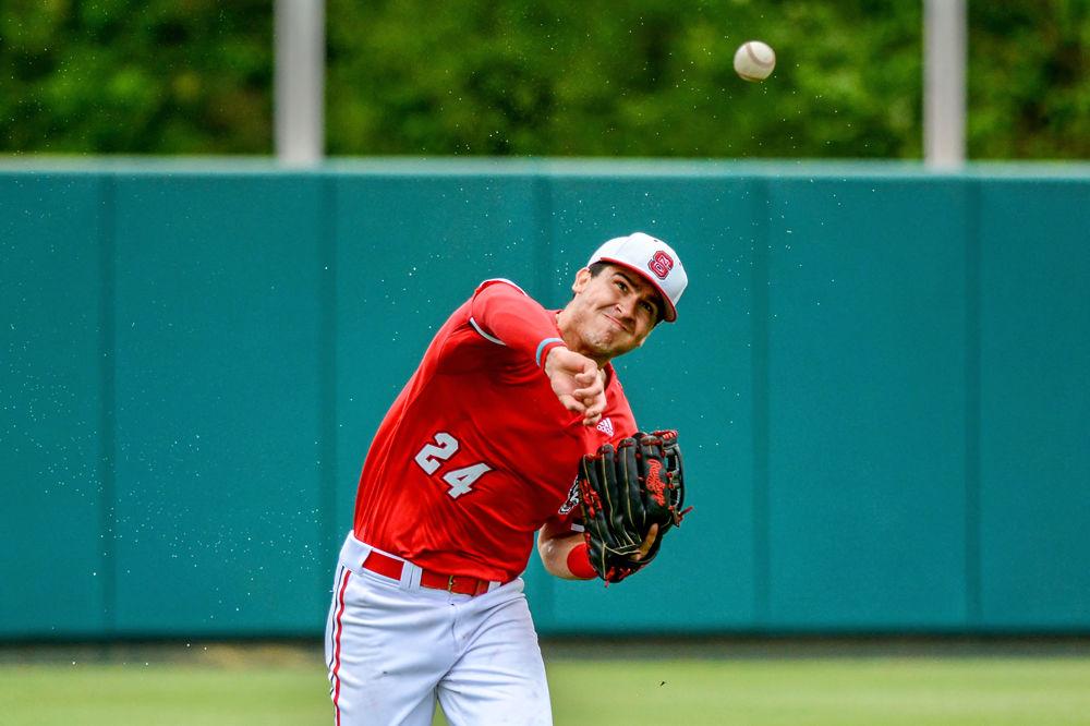 Freshman catcher and outfielder Luca Tresh throws the ball to the infield against Louisville on Saturday, April 13, 2019 at Doak Field. Tresh went 1-2 with one walk and one strikeout in the Wolfpack&#8217;s 14-10 loss to the Cardinals.