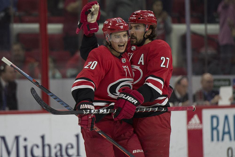 Center Sebastian Aho and defenseman Justin Faulk share a hug after Faulk scores during a power play in the second period against the New Jersey Devils, Thursday, April 4 in PNC Arena. The Canes beat the Devils, 3-1 and clinched a spot in the playoffs.&#160;