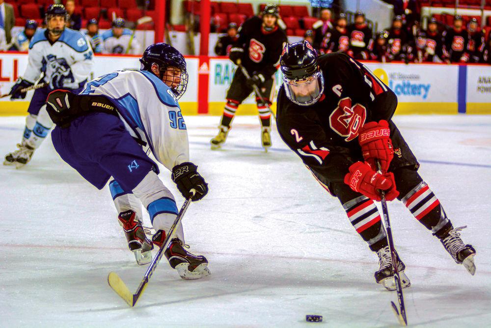 Fourth-year captain Sam Banasiewicz skates past the UNC defense during the annual Backyard Brawl on Monday, Oct. 22, 2018 in PNC Arena. The Icepack beat the Tar Heels 9-5.