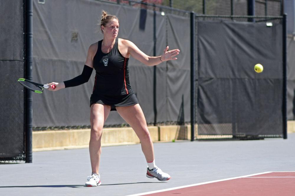 Junior Anna Rogers winds up to return a volley against Virginia Tech during a doubles match on Sunday, March 24, 2019 at J.W. Isenhour Tennis Center. Rogers and senior Claudia Wiktorin defeated Virginia Tech senior Sarah Baron and junior Natalie Novotna 6-2 during the Wolfpack&#8217;s 5-2 overall win against the Hokies.
