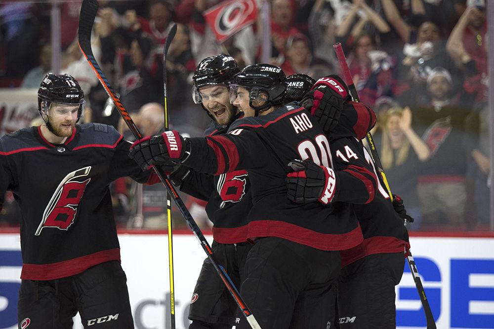 Warren Foegele skates up to join a celebration with Brett Pesce, Sebastian Aho and Justin Williams after Williams and Aho scored the third goal of the game in PNC Arena, Wednesday, May 1. The Canes beat the New York Islanders with home ice advantage, 5-2, and lead the series with a 3-0 advantage.