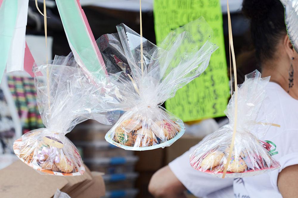 Bakery La Dolce Vita hangs cookies on display at their table at the international food festival on Saturday, Jun. 8, 2019 at City Plaza in downtown Raleigh.