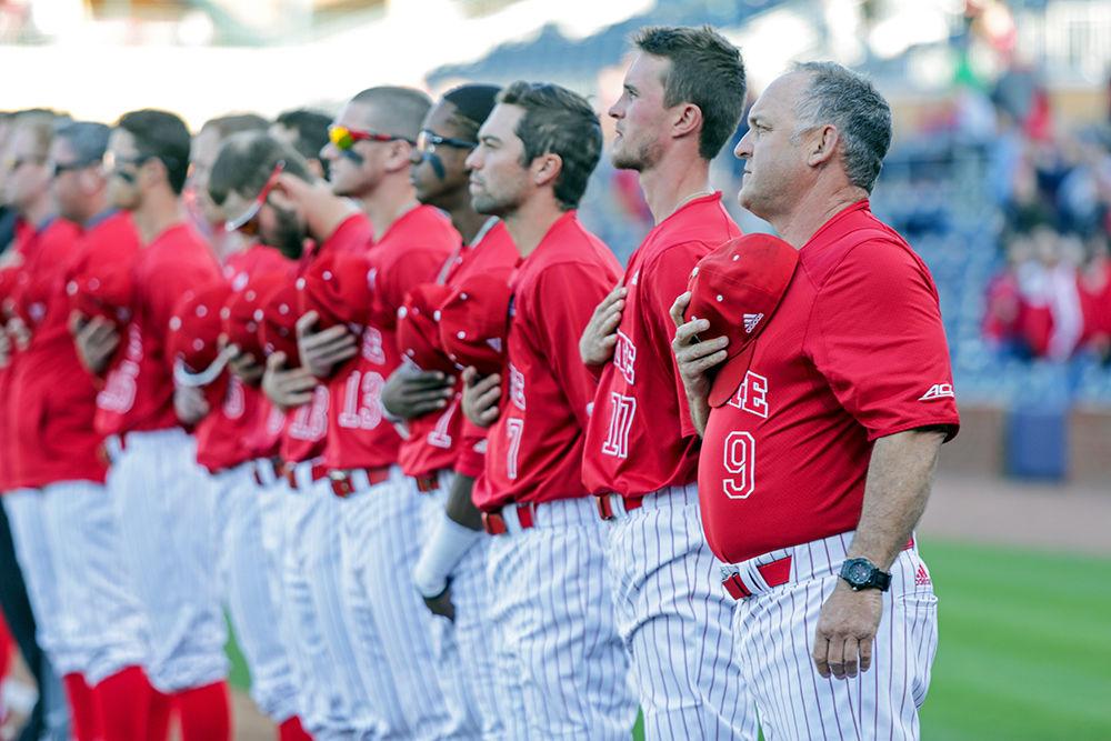 Head coach Elliott Avent and the rest of the team stand with hands across hearts for the national anthem prior to the 8-3 win over UNC-Chapel Hill at the Durham Bulls Athletic Park on Tuesday, April 17, 2018.