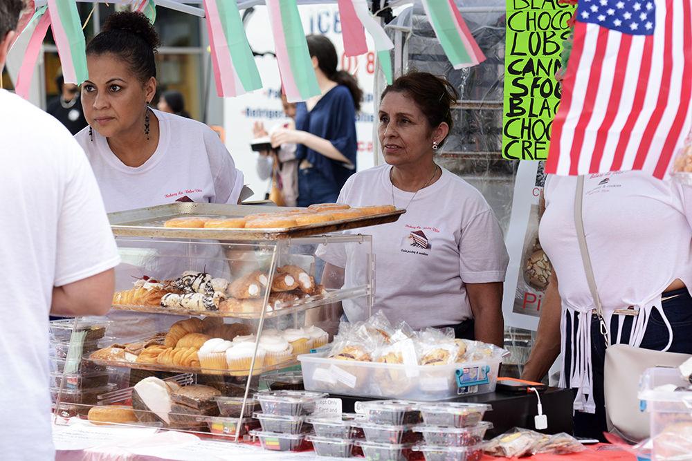Bakery La Dolce Vita employees Ana Ames and Gloria Valdes take orders from customers at the international food festival on Saturday, Jun. 8, 2019 at City Plaza in downtown Raleigh.