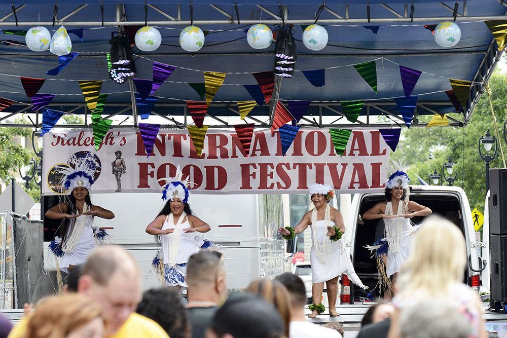 Performers dance at the international food festival on Saturday, Jun. 8, 2019 at City Plaza in downtown Raleigh.
