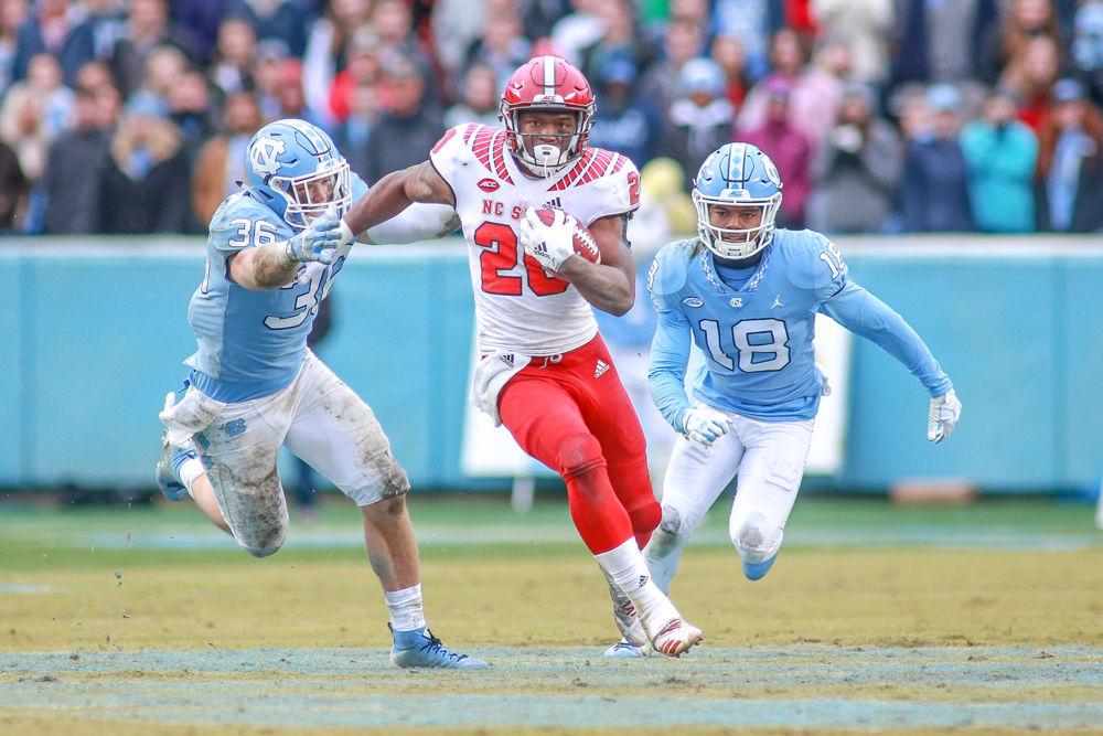 Freshman running back Ricky Person Jr. breaks through a hole for a big gain. Person had 68 yards on 16 carries. The Wolfpack won in an emotional 34-28 overtime win on Saturday Nov. 24 in Kenan Memorial Stadium.