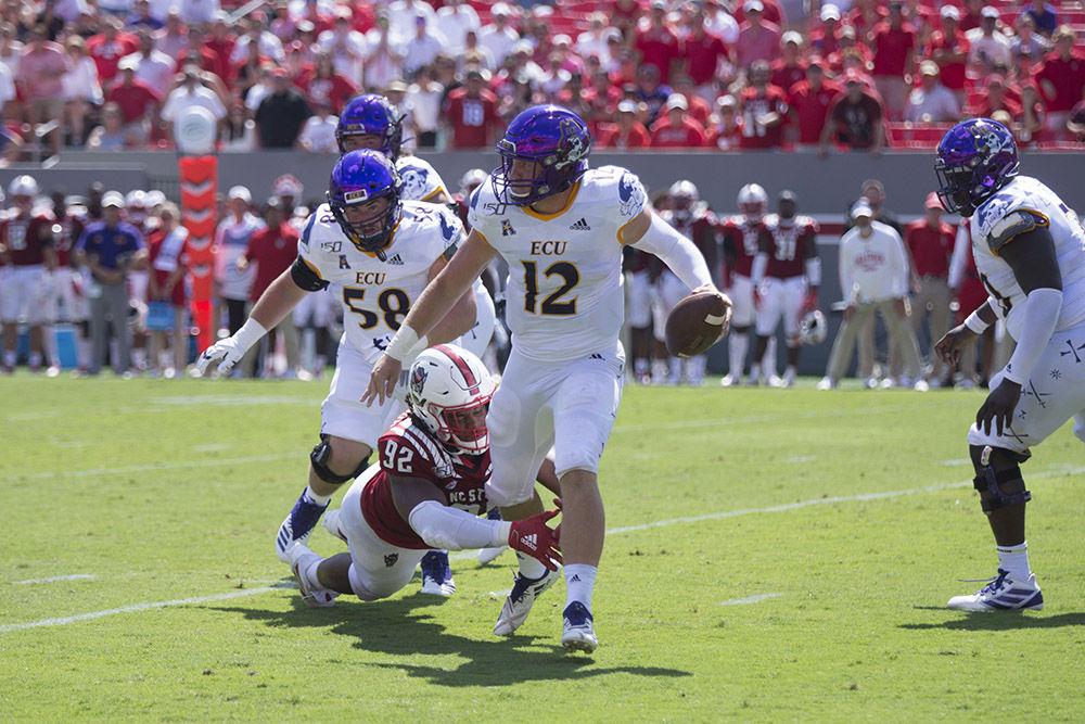 Redshirt senior defensive tackle Larrell Murchison grabs the leg of East Carolina University sophomore quarterback Holton Ahlers during the first game of the season in Carter-Finley Stadium, Saturday, Aug. 31, 2019. The Wolfpack won the first game of the season 34-6 in regulation, and will return to Carter-Finley Saturday, Sept. 7 to face Western Carolina University.