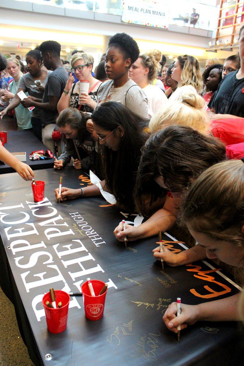 Students pledge to respect the Pack by signing their names on a banner on Aug. 21, 2018 at Respect the Pack. Respect The Pack, an annual Wolfpack Welcome Week event, brings students, faculty and staff, and administrators together for discussions of inclusion and diversity.