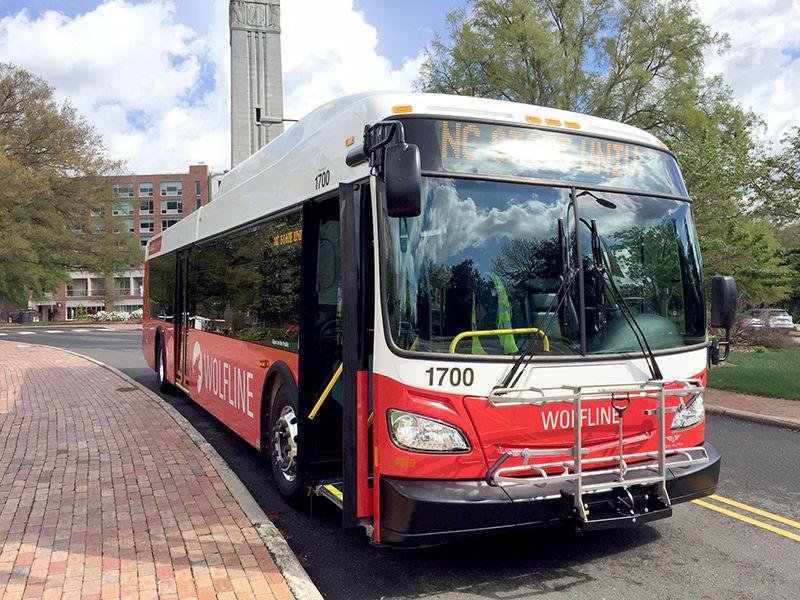 The logo and color scheme featured on the sides of Wolfline buses in the new fleet are designed by two students from the College of Design. They pay tribute to staple NC State symbols such as the howling wolf and the colors red and black.