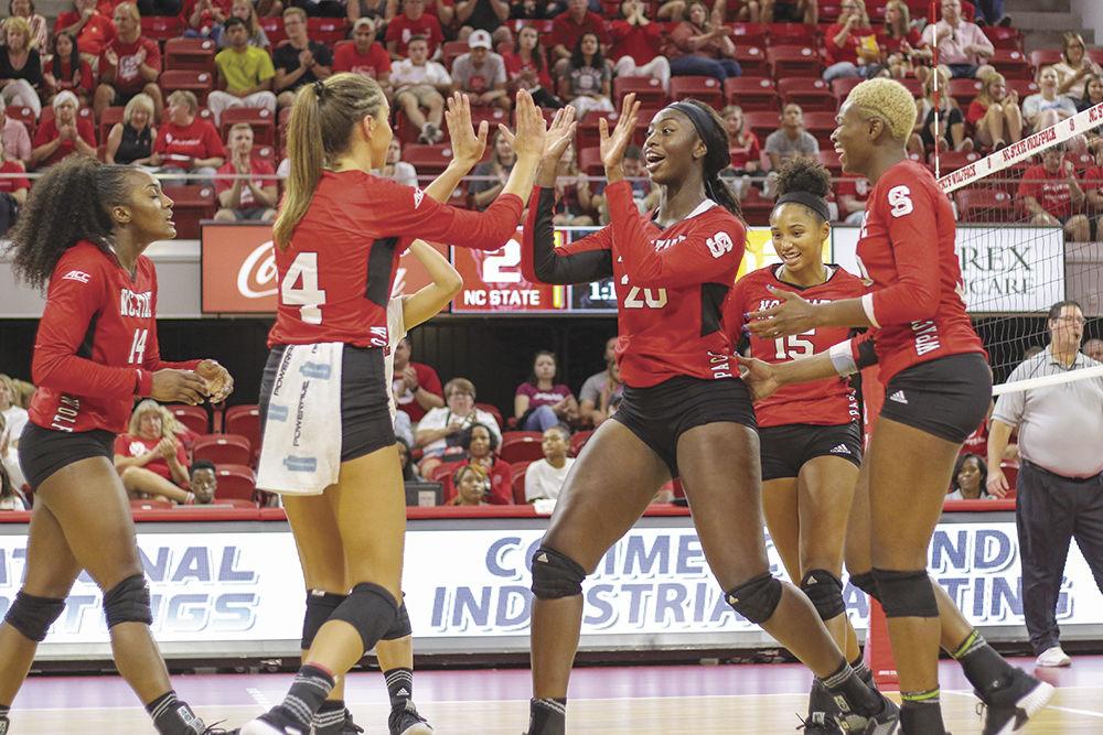 Junior middle blocker Lauryn Terry fives senior setter Kylie Pickrell to celebrate a point. The Wolfpack was able to pull out a 3-2 highly contested win over Virgina Commonwealth University on Friday, August 24 in Reynolds Coliseum.