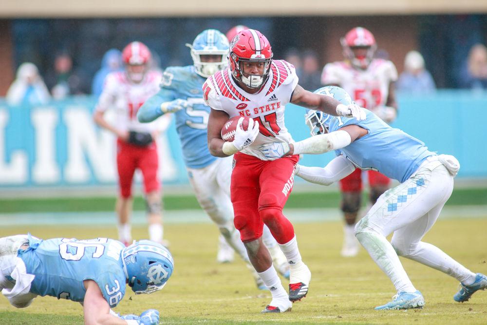 Redshirt junior wide receiver Jakobi Meyers shiftily dodges left and right to avoid tacklers. Meyers had 111 yards on seven receptions. The Wolfpack were tested by the Tar Heels, but came away with a 34-28 overtime win on Saturday, Nov. 24 in Kenan Memorial Stadium.