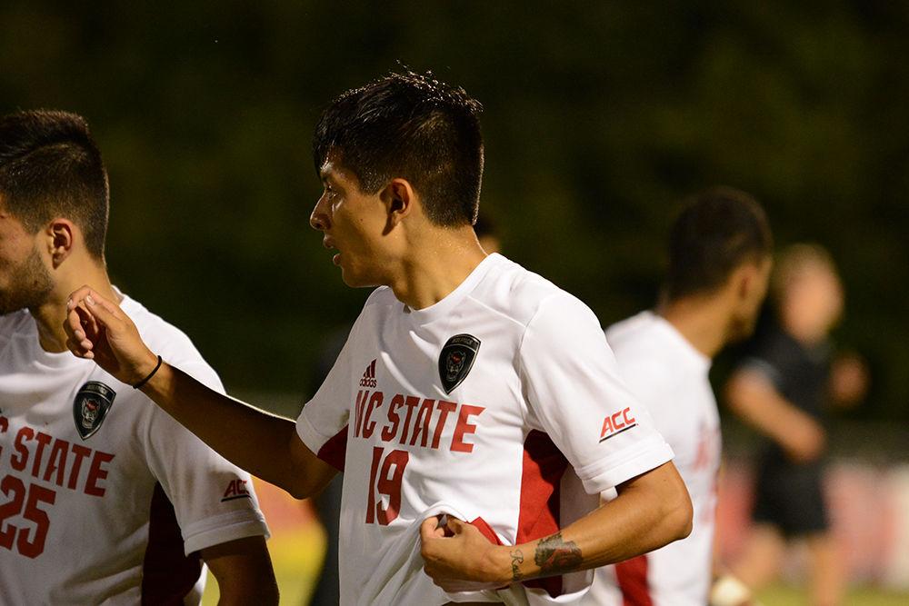 Sophomore defender Alex Bautista discusses strategy with the rest of the Wolfpack in the game against the Loyola Greyhounds on Friday, August 30th, 2019 in Dail Soccer Park. The defense helped ease the pressure on State's goalie, and only allowed Loyola to take 5 shots. NC State beat Loyola 2-1.
